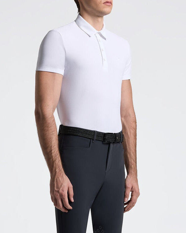 Man wearing black riding pants and a white shirt on a white background