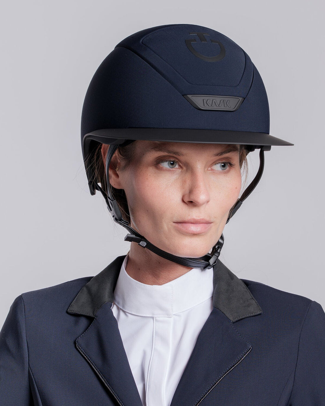Model wearing the Cavalleria Toscana CT Wide Brim Riding Helmet with signature CT logo, KASK branding and secure chinstrap, styled with equestrian competition clothing.
