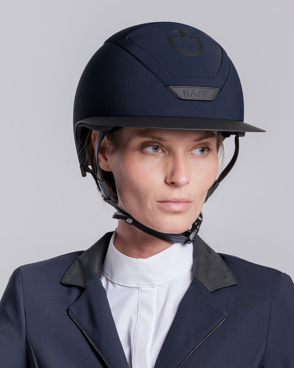 Model wearing the Cavalleria Toscana CT Wide Brim Riding Helmet with signature CT logo, KASK branding and secure chinstrap, styled with equestrian competition clothing.