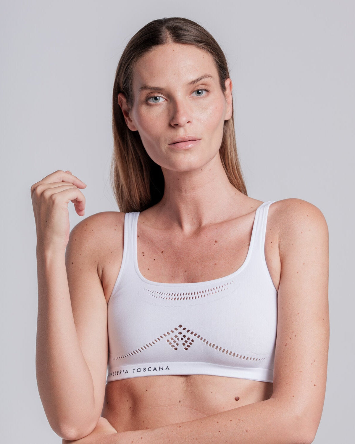 Model wearing the Cavalleria Toscana CT Technical Knit Sports Bra, featuring a seamless design, wide shoulder straps, breathable perforated detailing and signature CT logo.