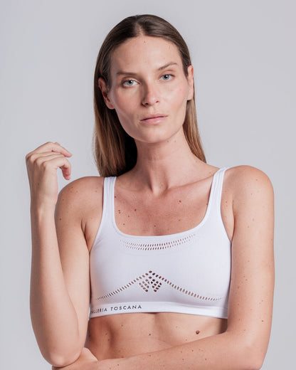 Model wearing the Cavalleria Toscana CT Technical Knit Sports Bra, featuring a seamless design, wide shoulder straps, breathable perforated detailing and signature CT logo.