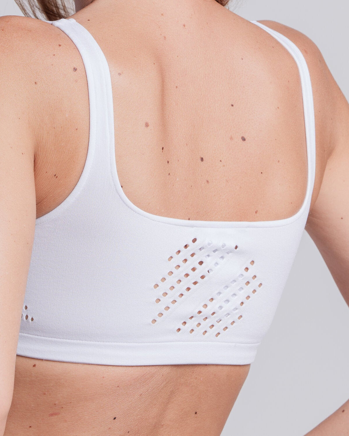 Model wearing the Cavalleria Toscana CT Technical Knit Sports Bra, featuring a seamless design, wide shoulder straps, breathable perforated detailing and signature CT logo.