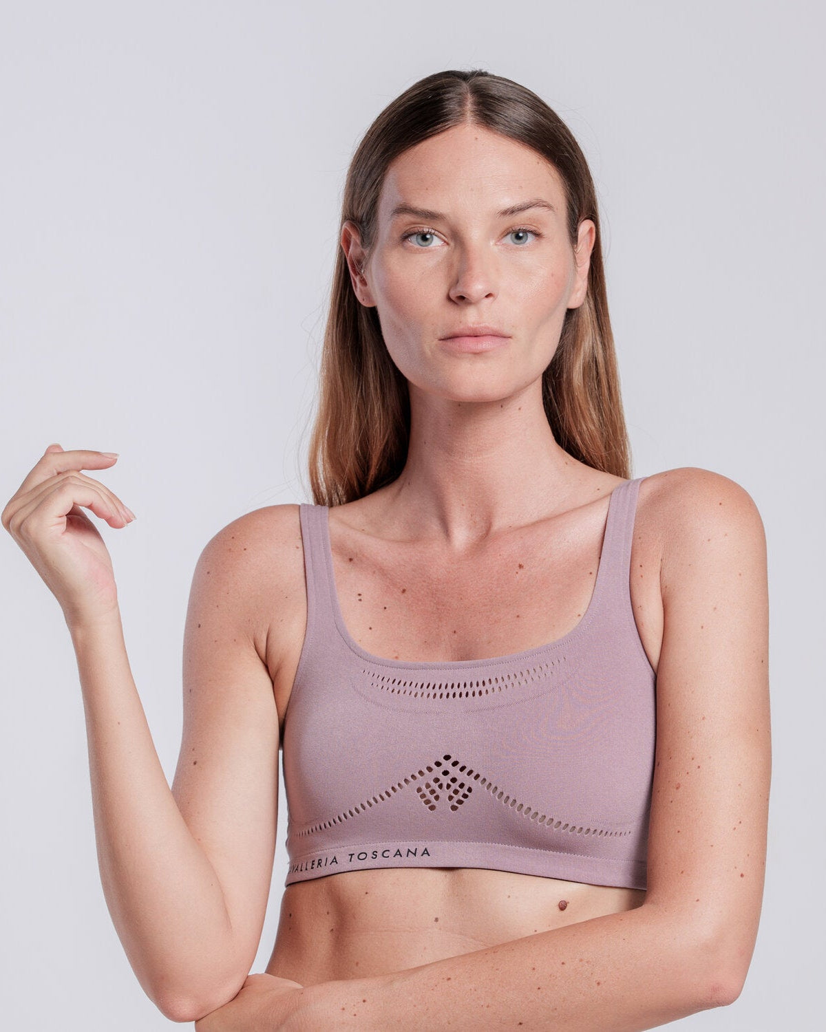 Model wearing the Cavalleria Toscana CT Technical Knit Sports Bra, featuring a seamless design, wide shoulder straps, breathable perforated detailing and signature CT logo.
