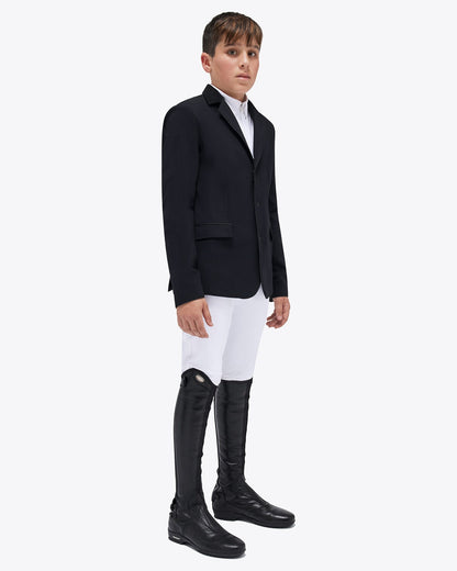 front view of a young rider wearing the Cavalleria Toscana CT Boys Competition Jacket With Zip, featuring a suede collar, tailored fit and buttoned cuffs.