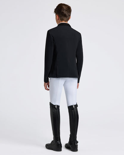 Rear view of a young rider wearing the Cavalleria Toscana CT Boys Competition Jacket With Zip, featuring a suede collar, tailored fit and buttoned cuffs.