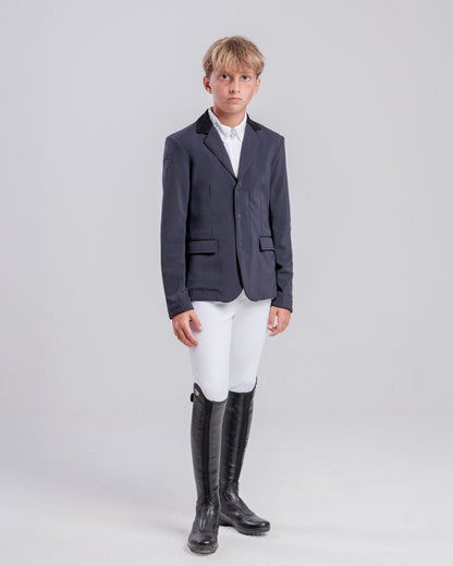 Front view of a young rider wearing the Cavalleria Toscana CT Boys Competition Jacket With Zip, featuring a suede collar, tailored fit and buttoned cuffs.