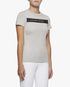 A model stands against a light gray studio background wearing a light gray short-sleeve athletic top with a black chest band reading: Cavalleria Toscana 